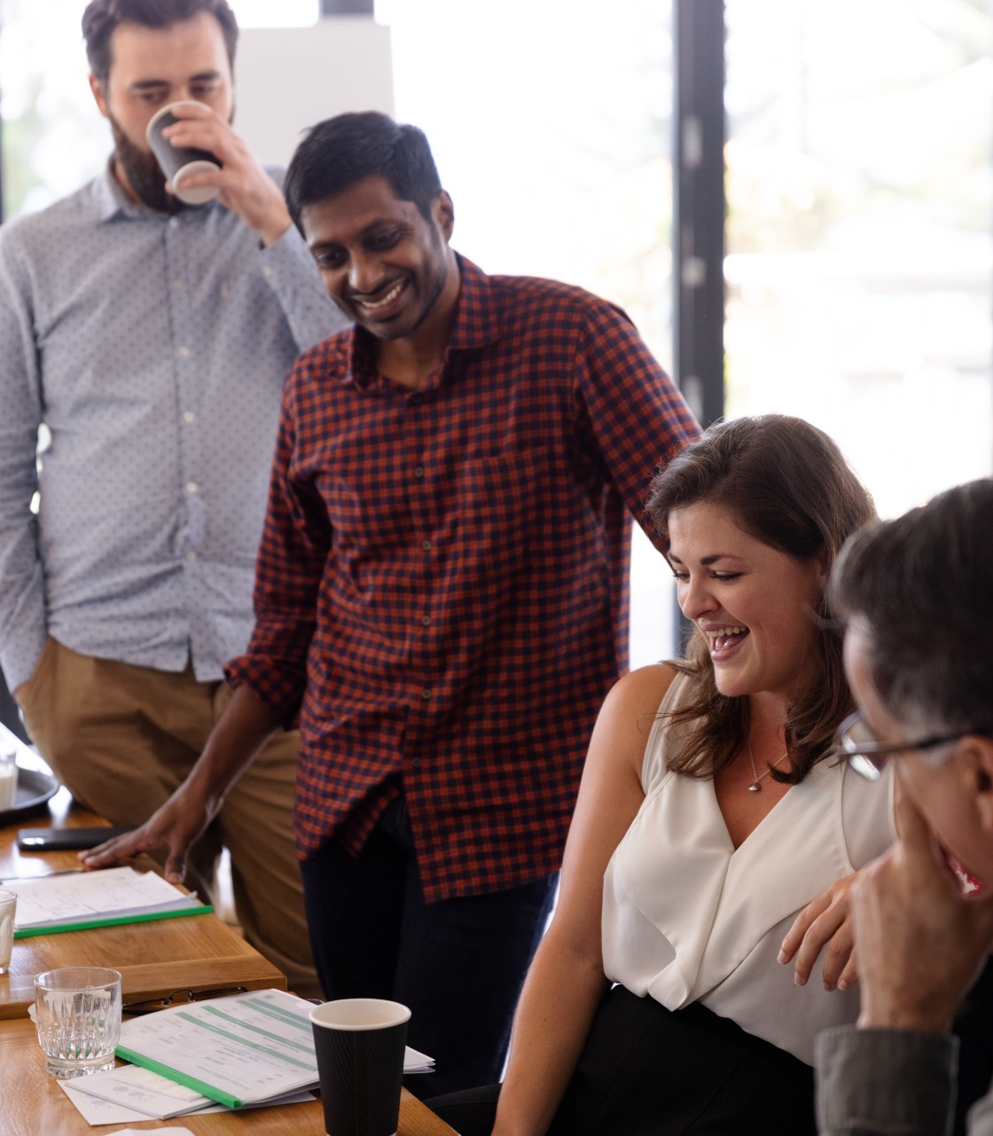 The Q5 team are here to help with any organisational health requirements. Q5 team members smiling, looking at a task.